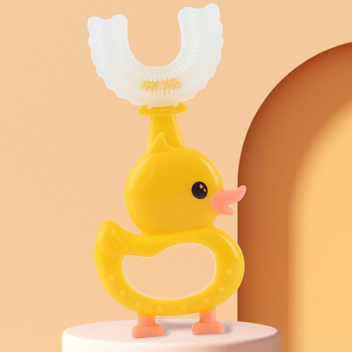 U-Shaped Training Toothbrush (2-pack): Duck U-shaped toothbrush standing on its feet, side view of the soft silicone head
